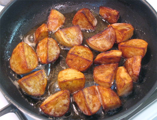 the cooked potatoes in the pan