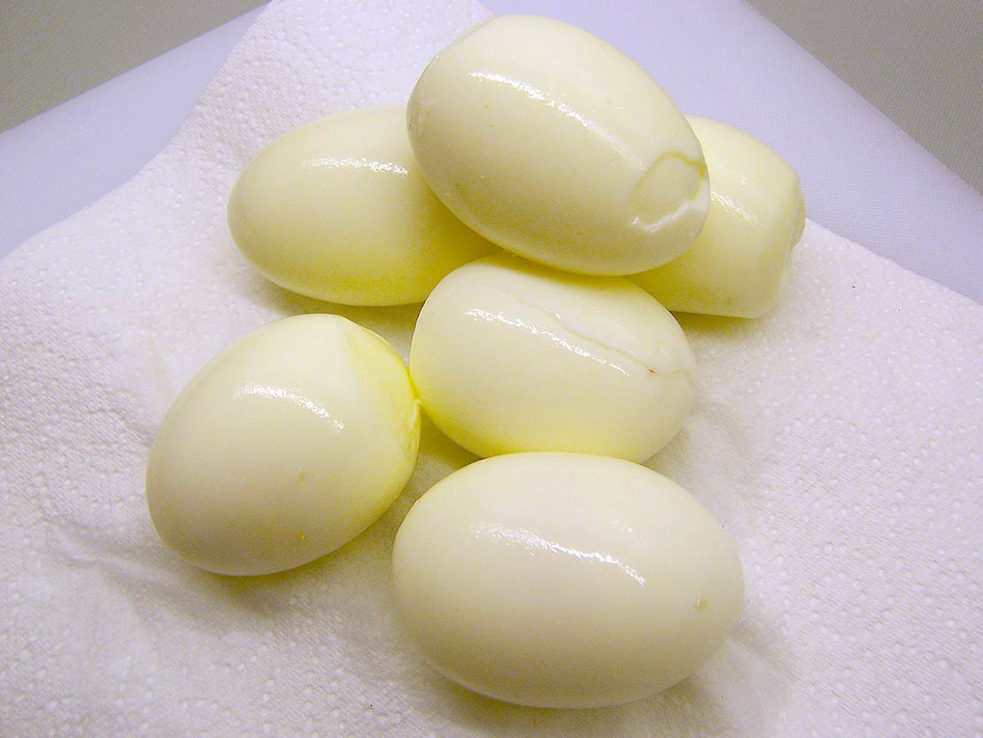 peeled, hard-boiled eggs