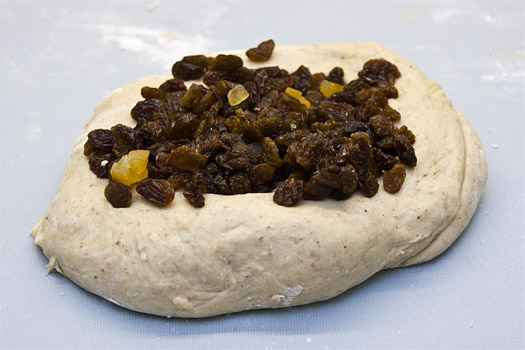 adding the fruit to the hot cross bun dough